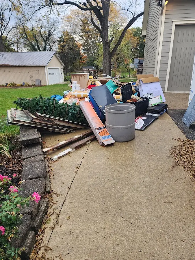Dumpster being loaded with debris for 12 Yard Dumpster Rental in Wagoner